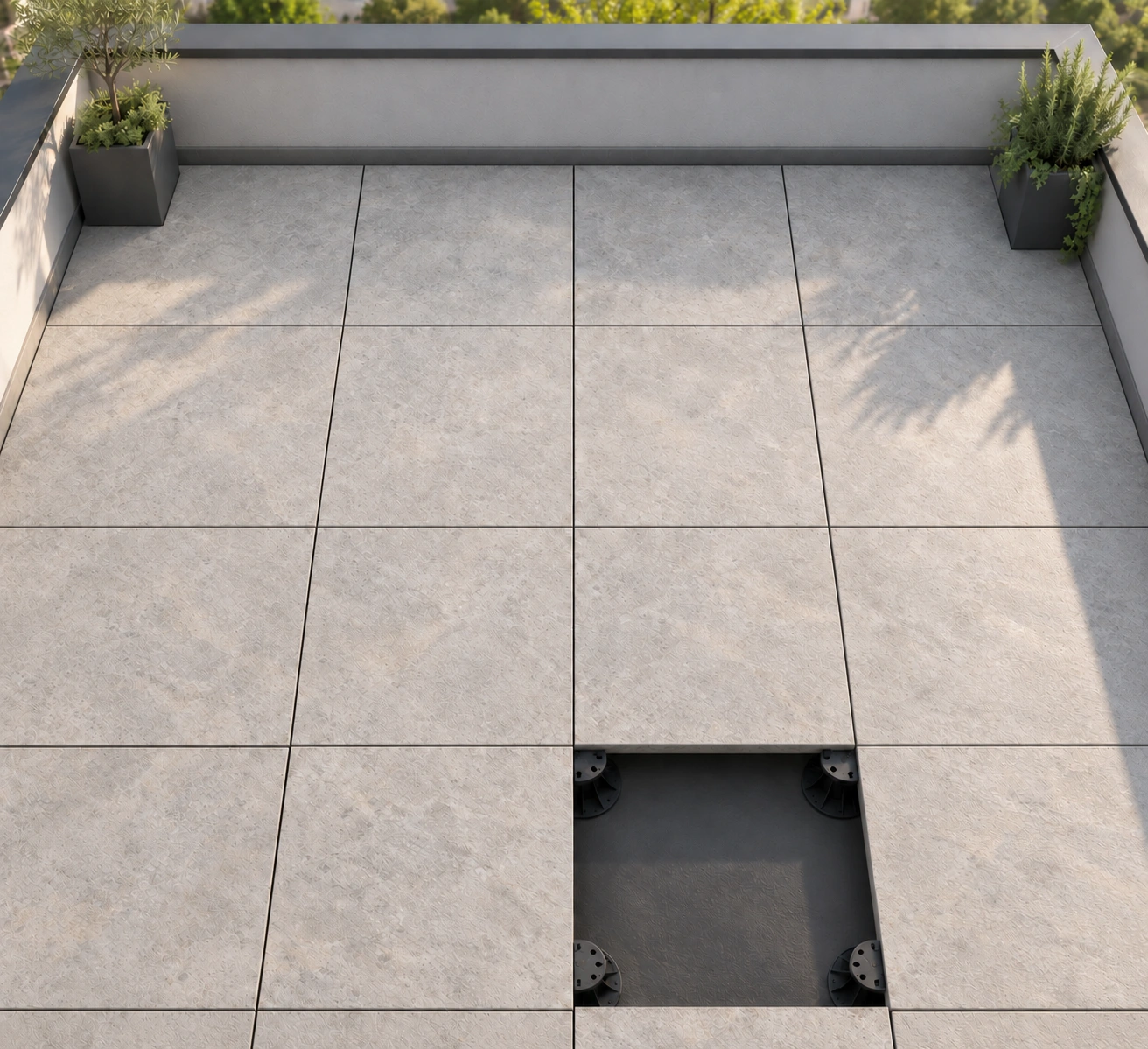 Terrasse en dalles sur plots aux joints alignés, vue de dessus avec une dalle retirée montrant les quatre appuis